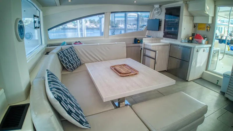 Jubilee Yacht Photos Pics Luxurious interior of a 2015 Leopard 48 yacht with modern seating and kitchen area.