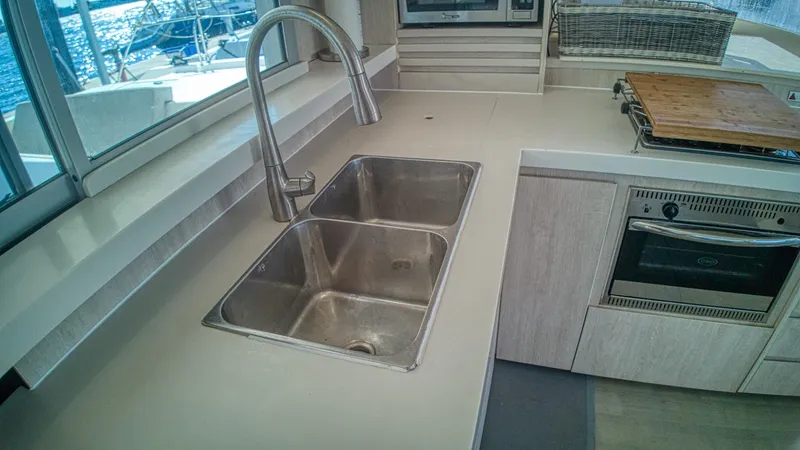 Jubilee Yacht Photos Pics Modern kitchen sink and countertop in a 2015 Leopard 48 yacht interior.