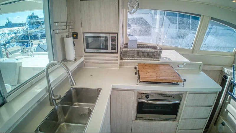 Jubilee Yacht Photos Pics Modern kitchen in a 2015 Leopard 48 yacht with dual sinks and appliances.