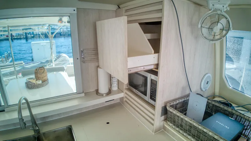 Jubilee Yacht Photos Pics Modern kitchen interior on 2015 Leopard 48 yacht with microwave and ocean view.