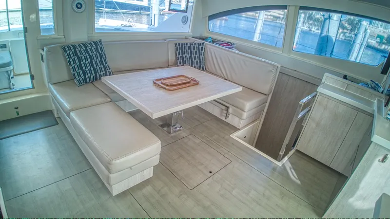 Jubilee Yacht Photos Pics Luxurious interior of 2015 Leopard 48 yacht with elegant seating and dining area.
