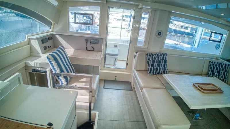 Jubilee Yacht Photos Pics Luxurious interior of 2015 Leopard 48 yacht with seating and helm station.