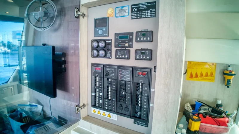 Jubilee Yacht Photos Pics Electrical control panel inside a 2015 Leopard 48 yacht, featuring various switches and gauges.