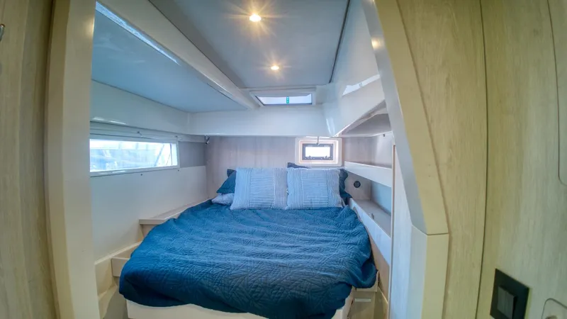 Jubilee Yacht Photos Pics Luxurious cabin interior of 2015 Leopard 48 yacht with cozy bed and modern design.