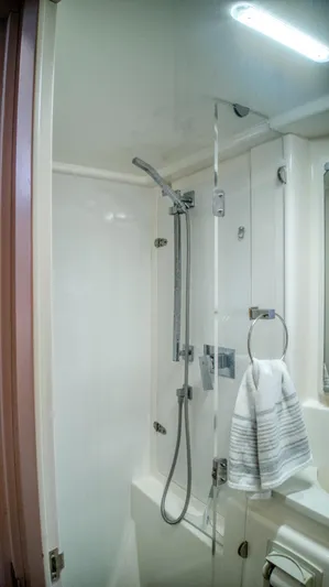 Jubilee Yacht Photos Pics Modern shower in 2015 Leopard 48 yacht with glass door and chrome fixtures.