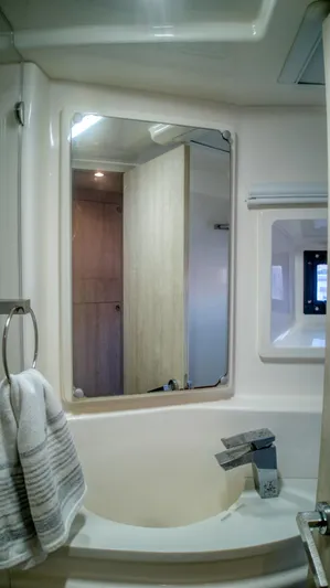 Jubilee Yacht Photos Pics Modern bathroom interior in a 2015 Leopard 48 yacht, featuring a mirror and sink.