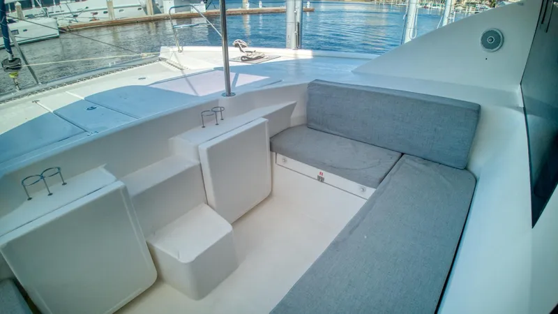 Jubilee Yacht Photos Pics Leopard 48 yacht interior seating area with gray cushions, docked at marina, 2015 model.