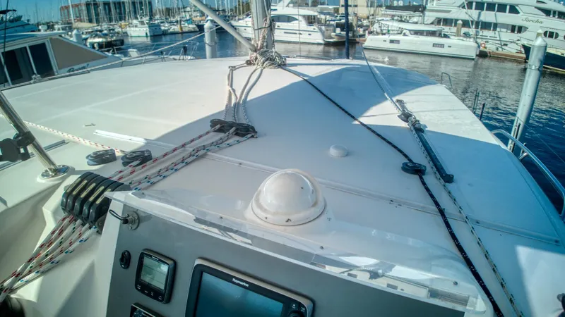 Jubilee Yacht Photos Pics Deck view of a 2015 Leopard 48 yacht in a marina, showcasing navigation equipment.