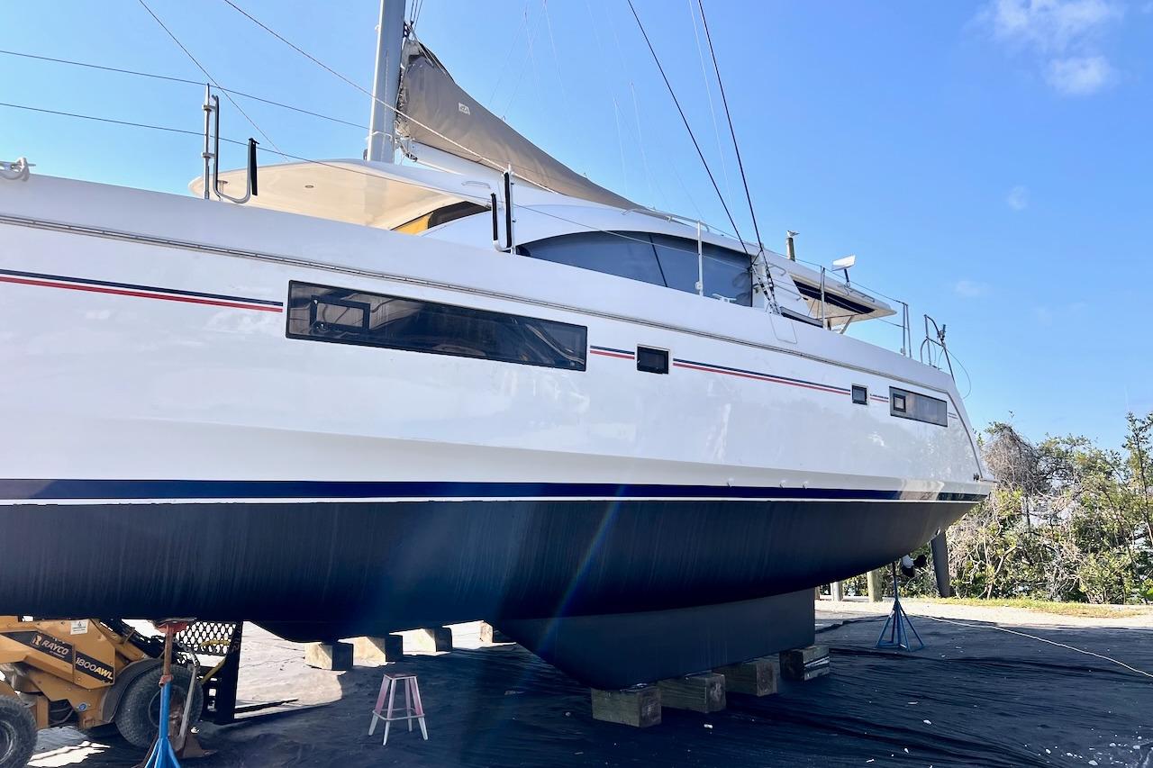 Leopard 48 catamaran from 2015 on dry dock, showcasing sleek design and modern features.