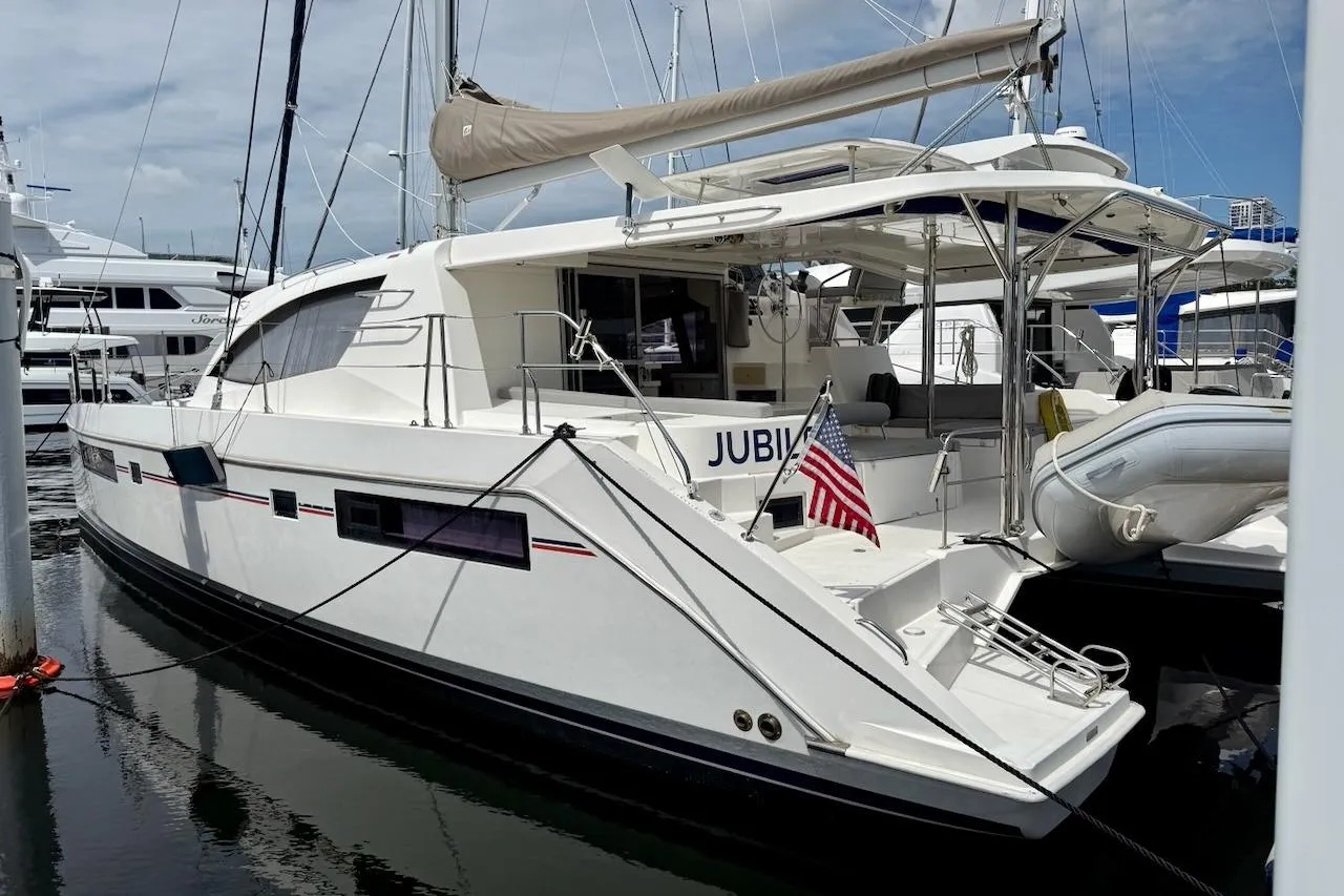 Luxury Leopard 48 yacht from 2015 docked at marina with American flag.