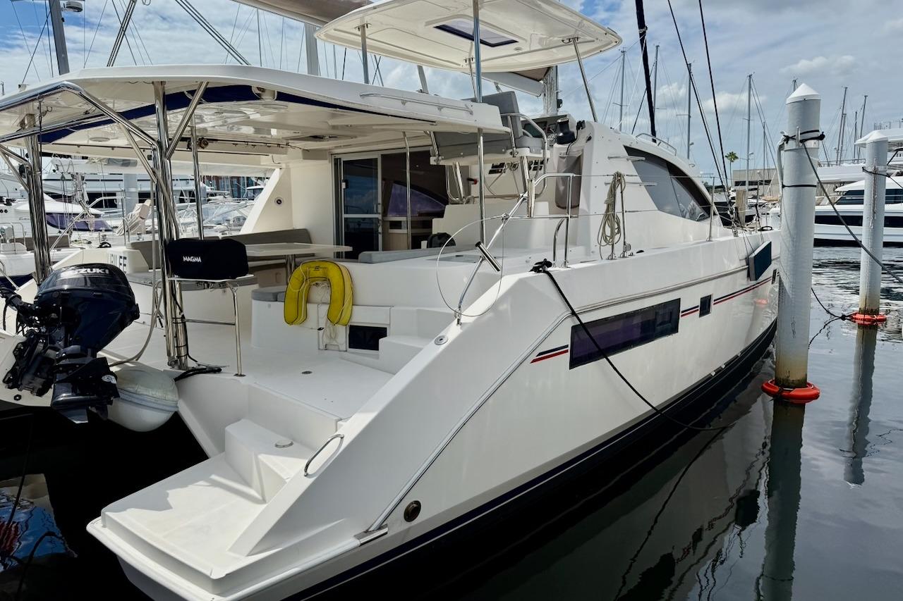 2015 Leopard 48 yacht docked at marina, featuring spacious deck and modern design.