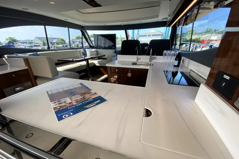  Yacht Photos Pics Luxurious interior of 2025 Riviera 465 SUV yacht with modern seating and sleek design.