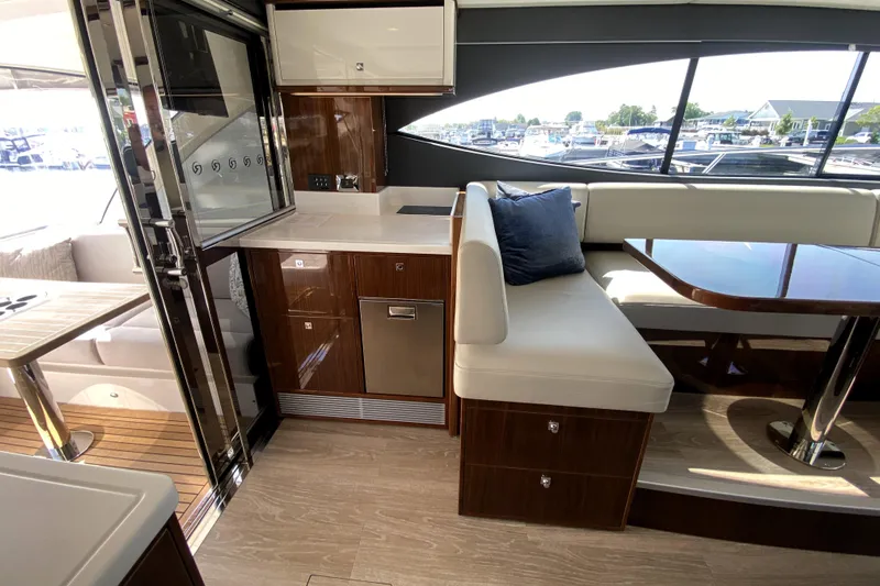  Yacht Photos Pics Luxurious interior of 2025 Riviera 465 SUV yacht with modern kitchen and seating area.