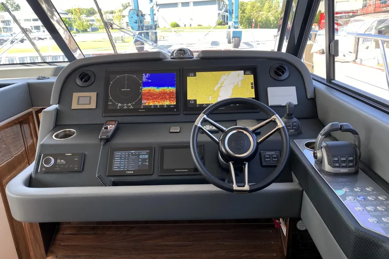  Yacht Photos Pics 2025 Riviera 465 SUV helm with advanced navigation and control systems.