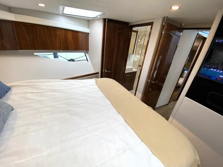  Yacht Photos Pics Luxurious interior of 2025 Riviera 465 SUV yacht with modern bedroom and sleek design.