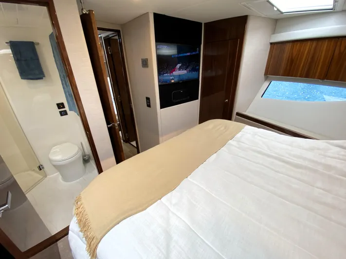  Yacht Photos Pics Luxurious bedroom interior of 2025 Riviera 465 SUV yacht with modern amenities.