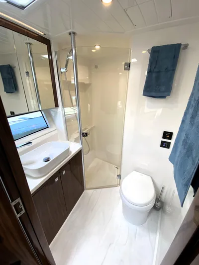  Yacht Photos Pics Luxurious bathroom in 2025 Riviera 465 SUV yacht with modern fixtures and elegant design.