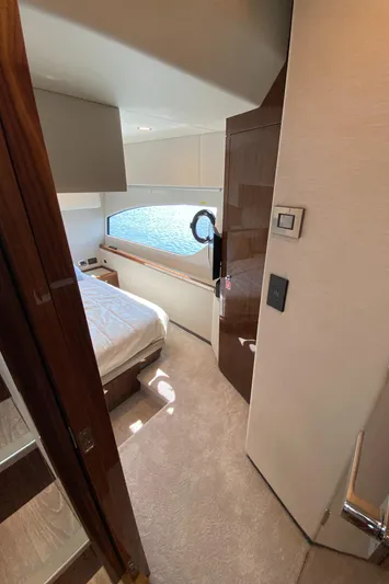  Yacht Photos Pics Interior of 2025 Riviera 465 SUV yacht, featuring a cozy bedroom with modern design.