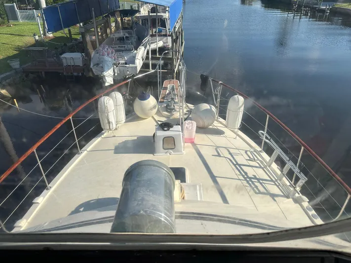 Luv'n Life Yacht Photos Pics 1989 Atlantic 47 Motor Yacht docked, view from deck, calm water, sunny day.