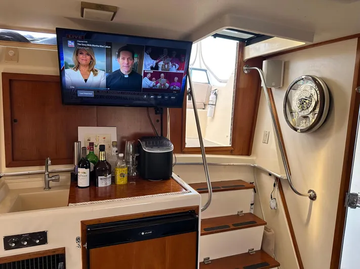 Luv'n Life Yacht Photos Pics Interior of 1989 Atlantic 47 Motor Yacht with TV, bar, and stairs.