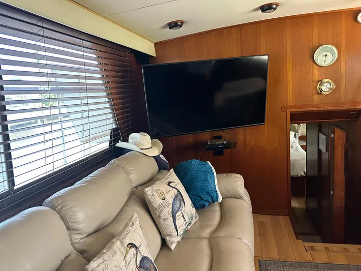 Luv'n Life Yacht Photos Pics Interior of 1989 Atlantic 47 Motor Yacht with cozy seating and wall-mounted TV.