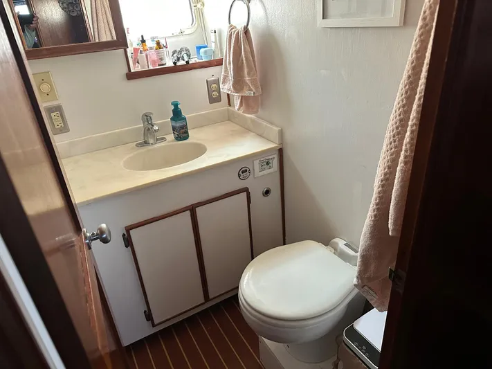 Luv'n Life Yacht Photos Pics Bathroom interior of 1989 Atlantic 47 Motor Yacht with sink and toilet.