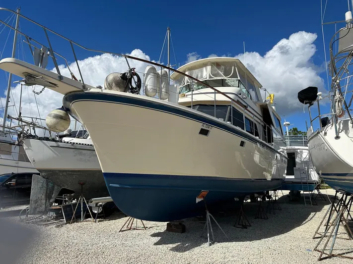 Luv'n Life Yacht Photos Pics 1989 Atlantic 47 Motor Yacht on dry dock under a clear blue sky.