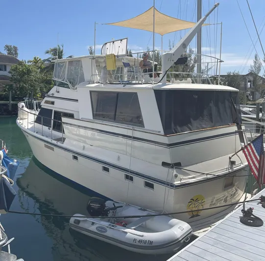 Luv'n Life Yacht Photos Pics 1989 Atlantic 47 Motor Yacht docked with inflatable boat and American flag.