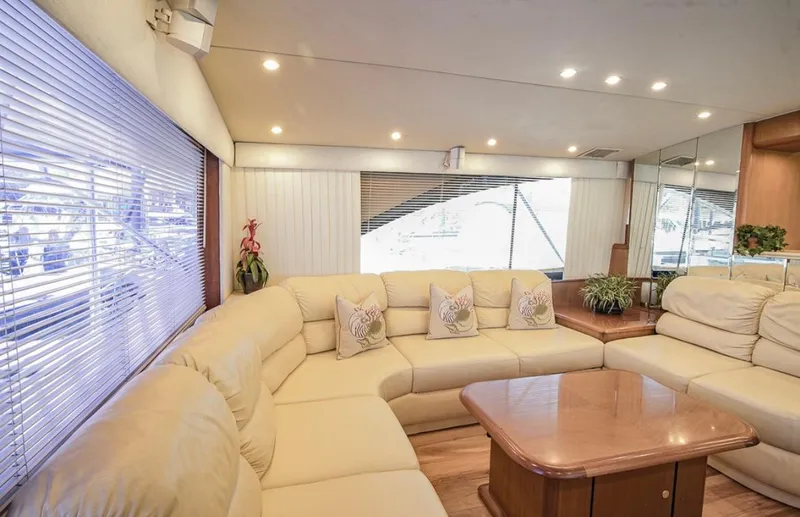  Yacht Photos Pics Luxurious interior of 1999 Ocean Yachts 60 Convertible with beige seating and wooden table.