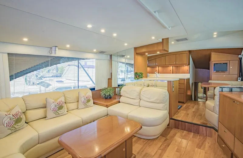  Yacht Photos Pics Luxurious interior of 1999 Ocean Yachts 60 Convertible with plush seating and wooden accents.