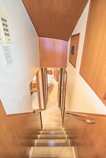  Yacht Photos Pics Staircase inside 1999 Ocean Yachts 60 Convertible, featuring wooden paneling and compact design.
