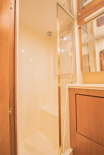  Yacht Photos Pics 1999 Ocean Yachts 60 Convertible yacht bathroom with shower and wooden cabinetry.