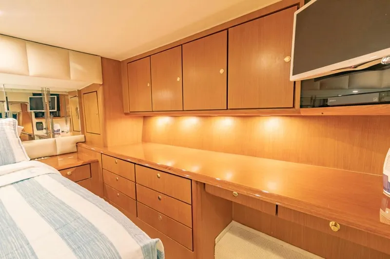  Yacht Photos Pics Luxurious cabin interior of a 1999 Ocean Yachts 60 Convertible with wood cabinetry and modern amenities.