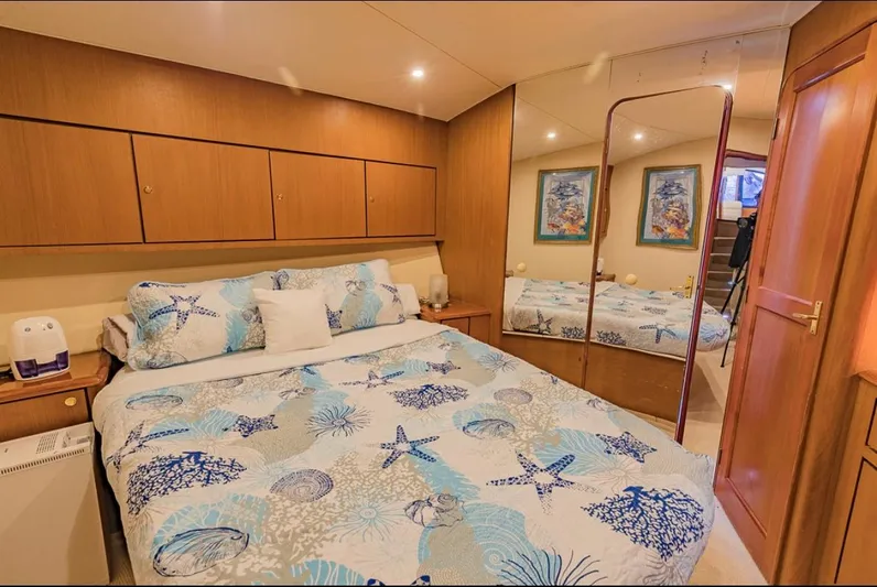  Yacht Photos Pics Luxurious bedroom in 1999 Ocean Yachts 60 Convertible with nautical-themed bedding.