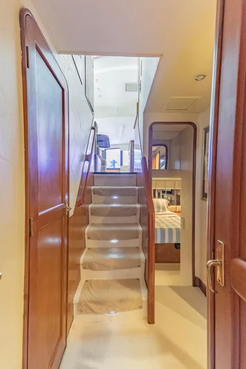  Yacht Photos Pics Interior view of 1999 Ocean Yachts 60 Convertible, featuring wooden stairs and cozy cabin.