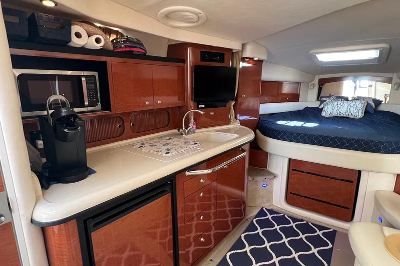  Yacht Photos Pics 2005 Sea Ray 340 Sundancer interior with kitchenette, bed, and modern amenities.