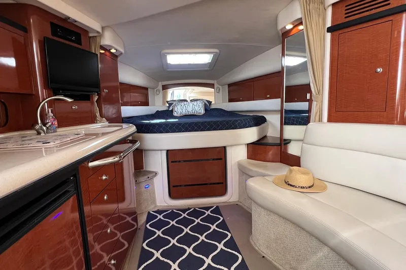  Yacht Photos Pics Luxurious interior of 2005 Sea Ray 340 Sundancer yacht with bed, seating, and kitchenette.