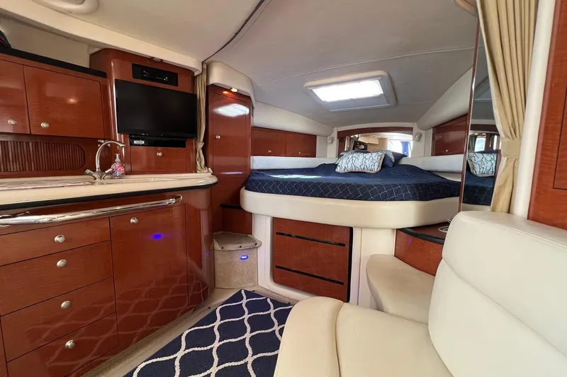  Yacht Photos Pics 2005 Sea Ray 340 Sundancer interior with luxurious wood cabinetry and cozy sleeping area.