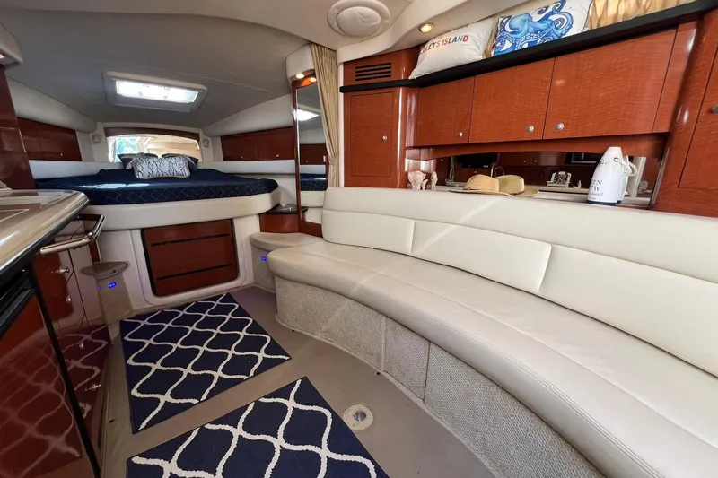  Yacht Photos Pics Luxurious interior of 2005 Sea Ray 340 Sundancer yacht with elegant seating and bedding.