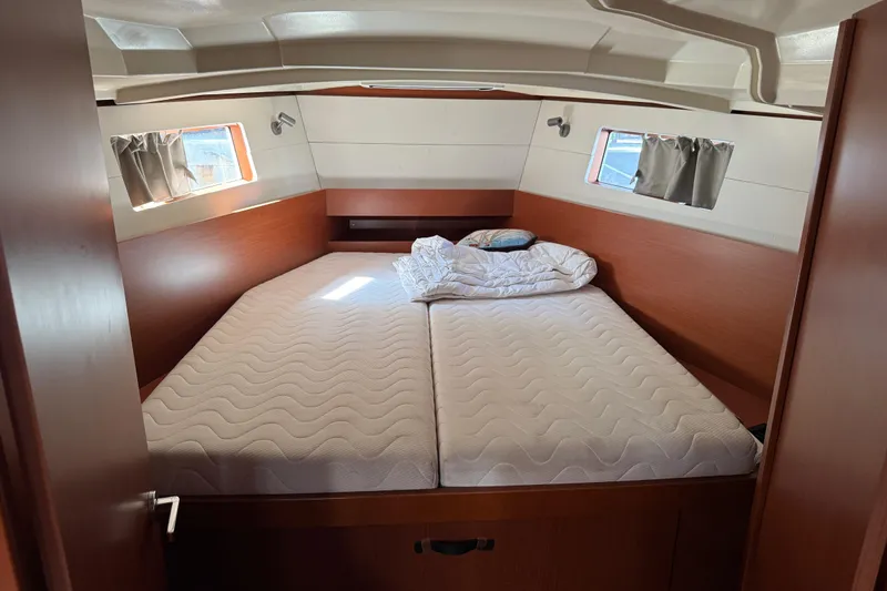 Take 2 Yacht Photos Pics 2019 Beneteau Oceanis 41.1 cabin interior with double bed and porthole windows.