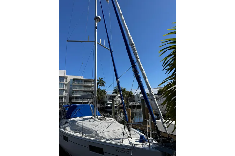 Take 2 Yacht Photos Pics 2019 Beneteau Oceanis 41.1 sailboat docked, with clear blue sky and palm trees.