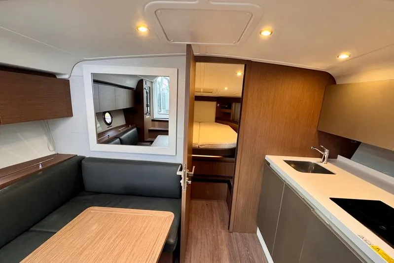  Yacht Photos Pics Interior of 2021 Beneteau Gran Turismo 40 yacht, featuring modern kitchen and cozy seating area.