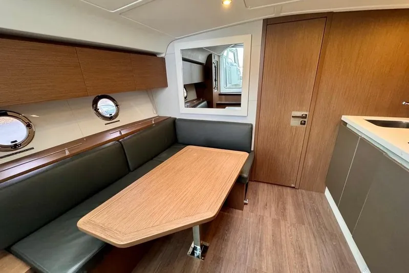  Yacht Photos Pics Interior of 2021 Beneteau Gran Turismo 40 yacht with modern dining area and wood finishes.