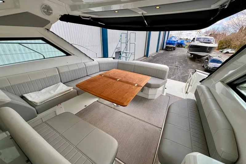  Yacht Photos Pics Interior of 2021 Beneteau Gran Turismo 40 yacht with seating and wooden table.