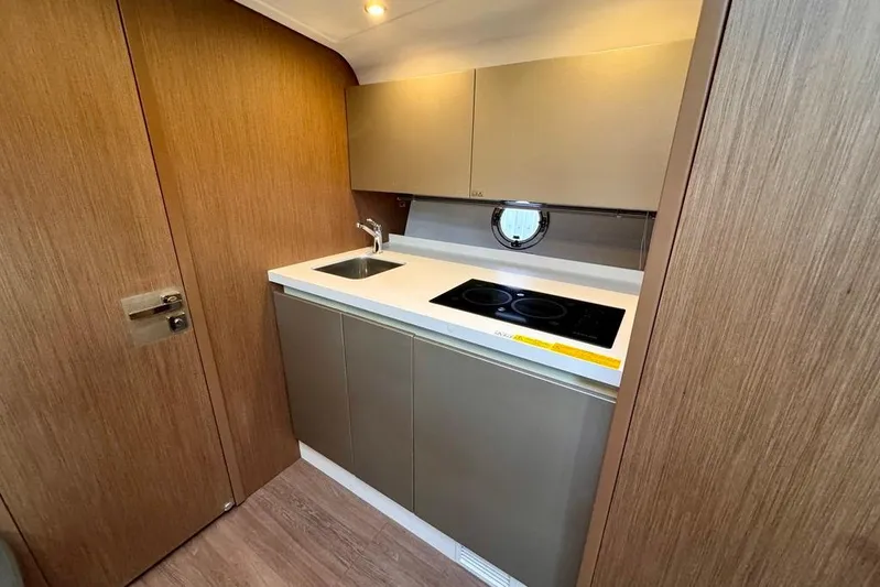  Yacht Photos Pics Compact kitchen in 2021 Beneteau Gran Turismo 40 yacht with modern amenities.