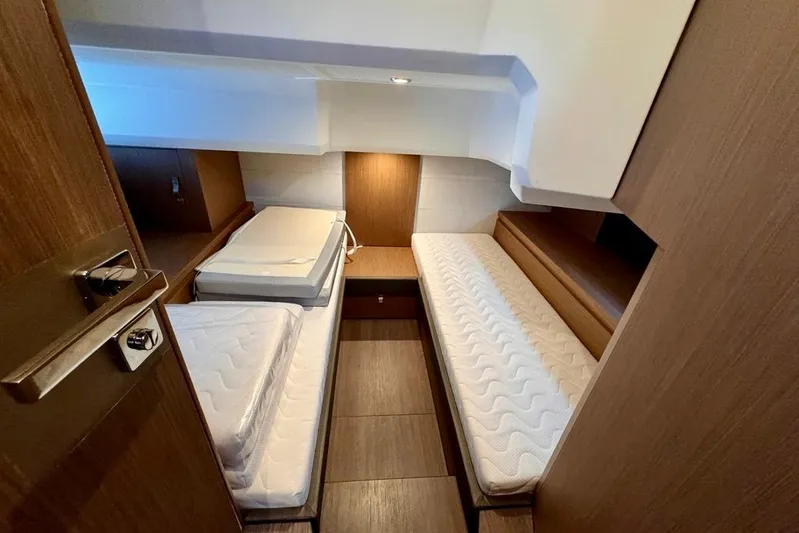  Yacht Photos Pics Interior cabin of 2021 Beneteau Gran Turismo 40 with twin beds and wooden finish.