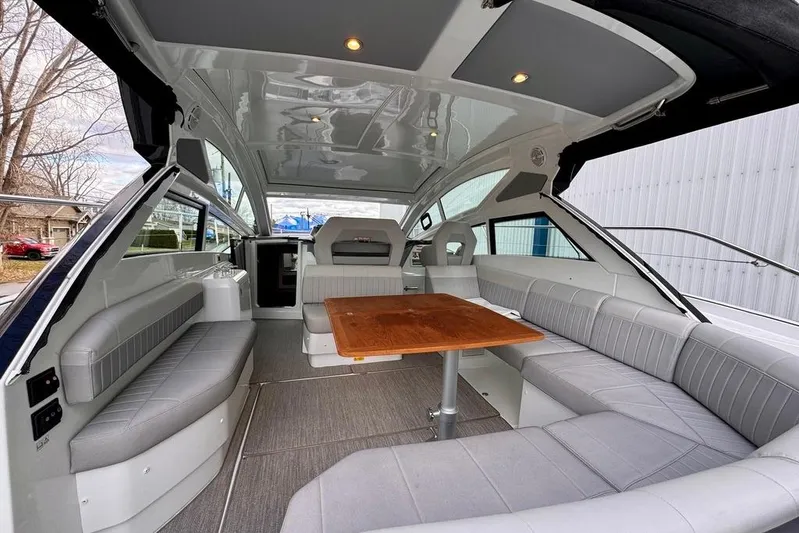  Yacht Photos Pics Interior of 2021 Beneteau Gran Turismo 40 yacht with spacious seating and wooden table.