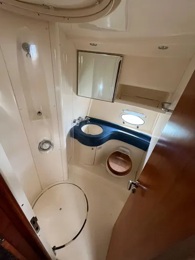  Yacht Photos Pics 2005 Azimut 43 yacht bathroom with modern fixtures and porthole window.