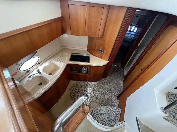  Yacht Photos Pics 2005 Azimut 43 yacht interior kitchen with wooden cabinetry and modern appliances.