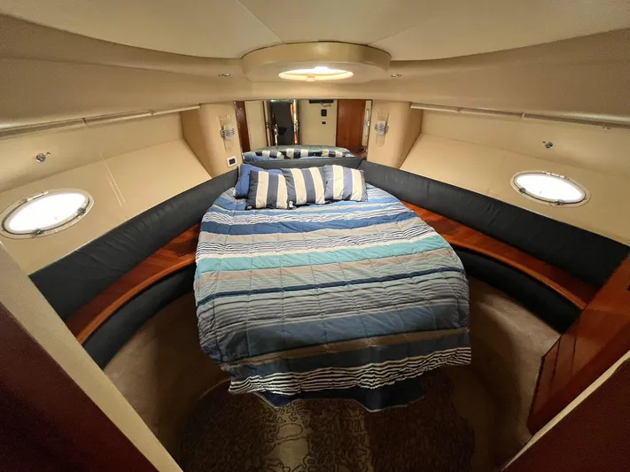  Yacht Photos Pics Luxurious cabin interior of a 2005 Azimut 43 yacht with striped bedding.